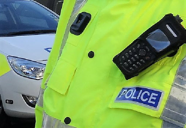 Police Scotland officer beside police car
