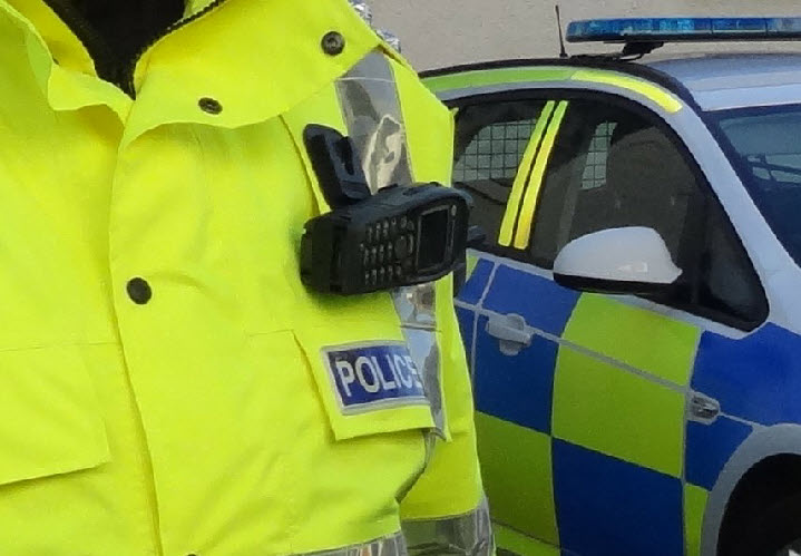 Police officer by poice car